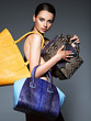 © Valua Vitaly - Beautiful naked woman holds fashion handbags