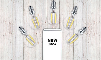 new ideas. telephone on the table and light bulbs. background for ideas