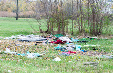 Garbage Dump On The Grass Near The Forest Ecological Disaster Concept Polluting Nature And City Park With Litter