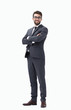 © ASDF - Young businessman standing with hands in pockets.