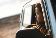 Woman Looking Out The Window Of Her Car