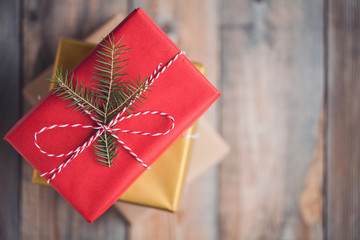 Christmas background with gift boxes on wooden background. Top view with copy space. Beautifully packaged gifts for new year or Valentine's day