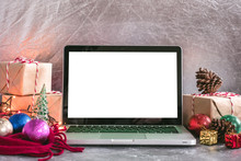 Laptop With White Screen, Gift Boxes And Christmas Decoration On The Table.
