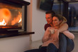 © .shock - happy couple in front of fireplace
