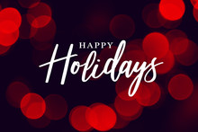 Happy Holidays Calligraphy With Red Duotone Bokeh Lights Background