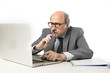 © Wordley Calvo Stock - corporate portrait bald 60s serious and bossy business man thinking and working at computer laptop office desk