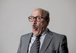 © Wordley Calvo Stock - portrait of 60s bald senior happy business man gesturing funny and comic in laughter and fun face expression looking happy