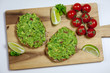 Healthy homemade sandwich with guacamole. Traditionally mexican dish. Lime, tomato, parsley on the background