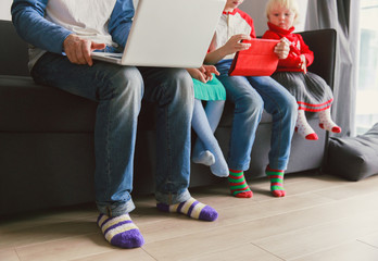 Wall Mural - father and kids looking at laptop and touch pad at home