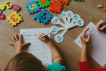 Wall Mural - kids learning to write letters doing homework