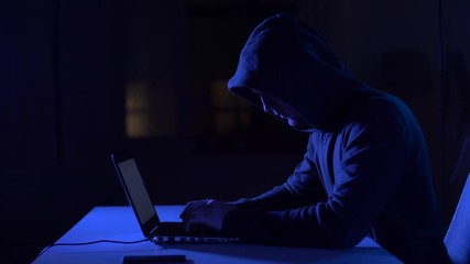 hacker using laptop computer for cyber attack