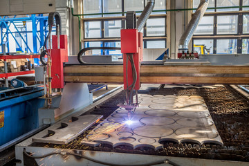 Wall Mural - robot laser cutting metal on metalworking plant