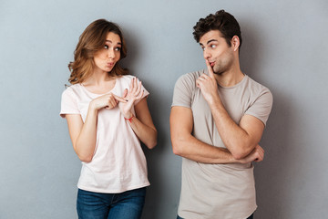 Poster - Portrait of a young attractive couple showing peace gesture