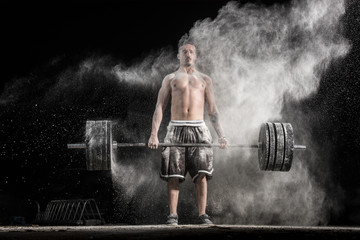 Man Holding a Weight in the Gym