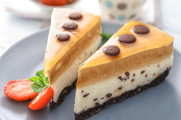 Wall Mural - Pieces of layered mousse cake with caramel on plate, closeup