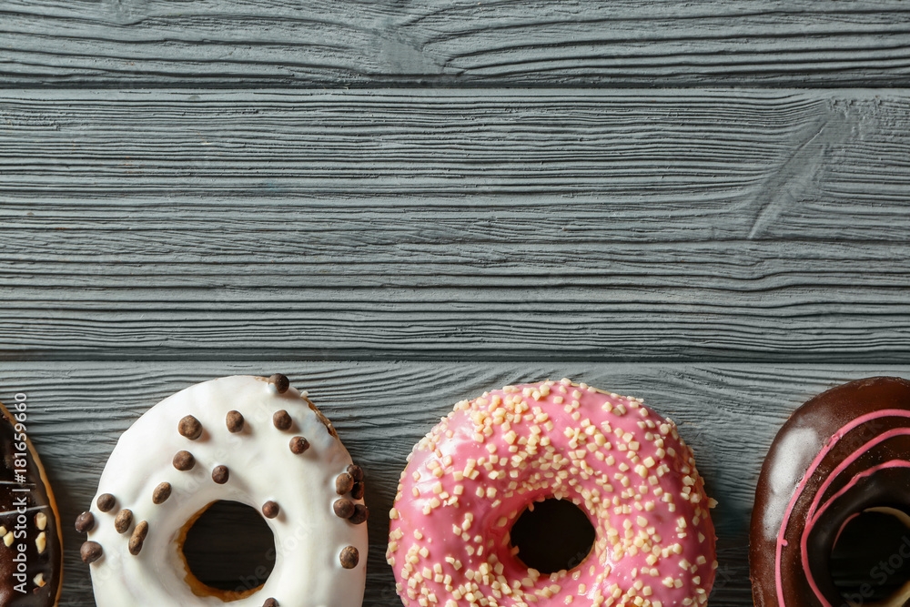 Tasty donuts on wooden table