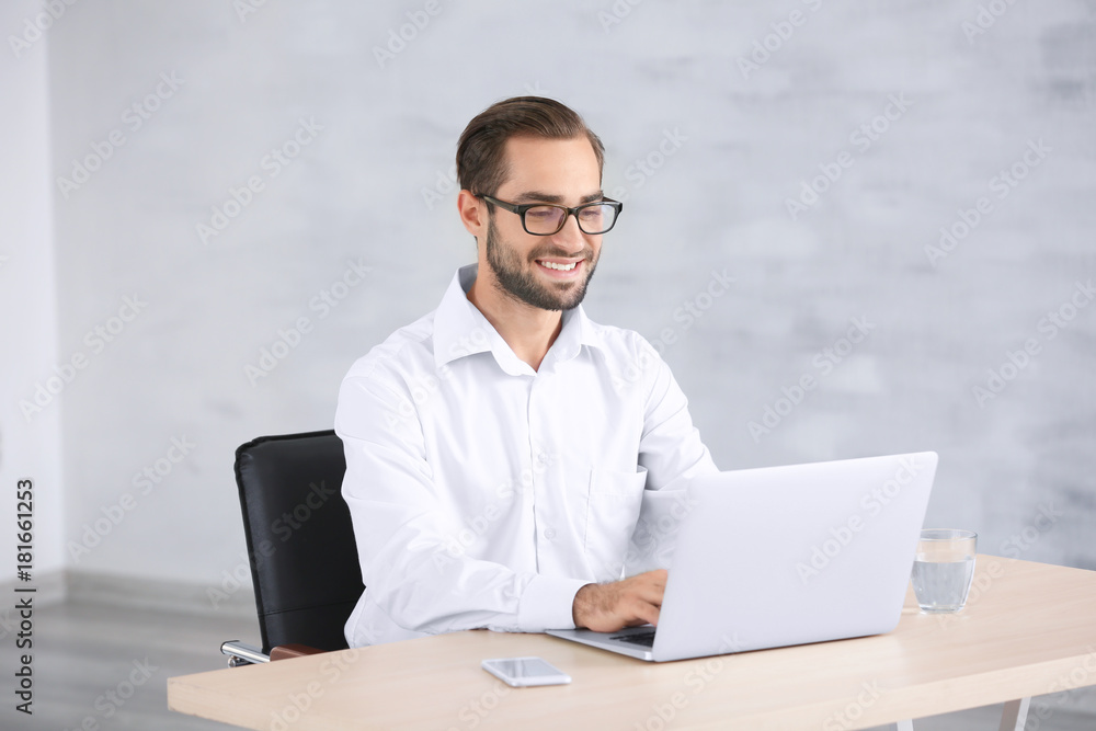 Attractive man with laptop at home