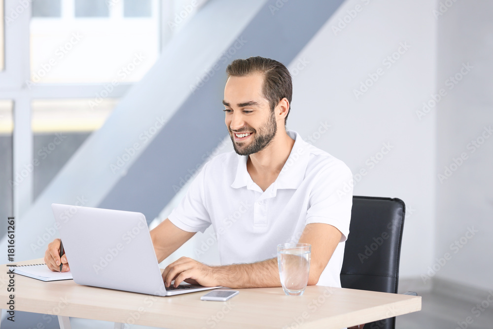 Attractive man with laptop at home