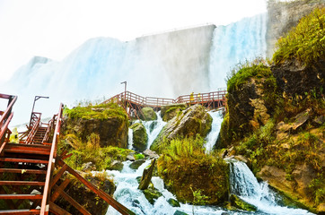 view from the bottom of niagara falls at american side with water splashing in the air