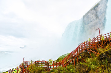 Wall Mural - view from the bottom of niagara falls at american side with water splashing in the air