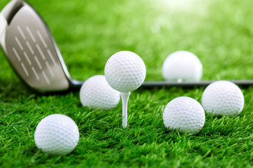 Wall Mural - Golf balls and golf club on green grass