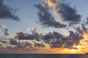 Wall Mural - Sunrise on the Caribbean sea shore. Dramatic clouds and colorful sunrise. Horizon level on low.