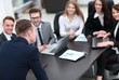 © ASDF - blurred image of business team at a Desk