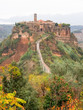 View of Civita de Bagnoregio from walkway with tourists during autumn season