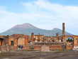 Roman forum, main square of the roman city of Pompeii ruins with dormant volcano Mount Vesuvius in the background