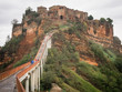 View of Civita de Bagnoregio from walkway with tourists