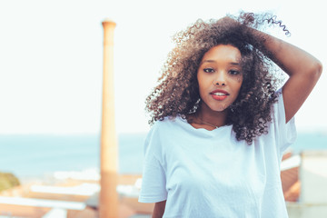 Young beautiful black woman on the stairs posing