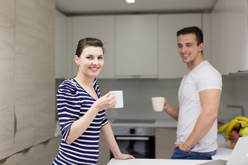 Wall Mural - couple with laptop computer enjoying morning