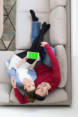 Wall Mural - couple relaxing at  home with tablet computers
