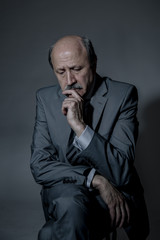 Wall Mural - portrait of sad and depressed senior mature business man on his 60s suffering depression looking lost and thoughtful wearing necktie