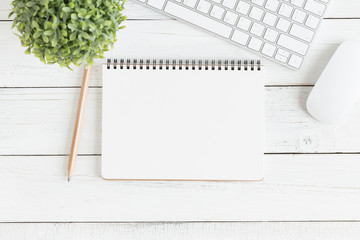 Flat lay photo of office desk with mouse and keyboard,Empty open notebook on white wood table top view