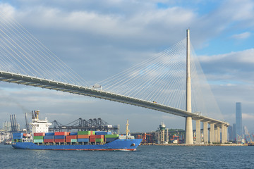 Container ship and bridge in Victoria Harbor of Hong Kong city