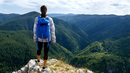 low angle of woman hiking on top of mountain at sunset hiker girl celebrating life scenic nature lan