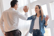 © zinkevych - Giving five. Emotional young smiling woman giving five to her kind loving husband while being excited about getting a new wonderful well paid job