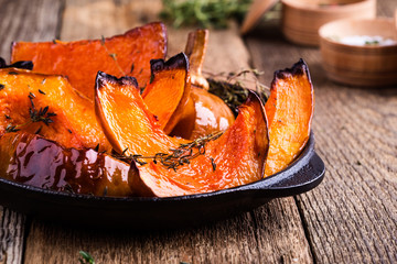 Wall Mural - Baked pumpkin with thyme in cast iron skillet