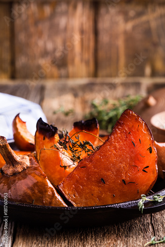 Baked pumpkin with thyme in cast iron skillet Poster
