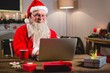 © WavebreakMediaMicro - Santa Claus using laptop on table