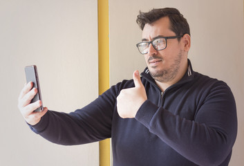 Handsome businessman taking a selfie with a mobile phone