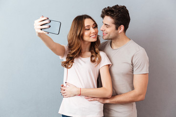 Canvas Print - Portrait of a happy young couple hugging