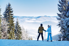 Couple Of Skiers On Winter Resort