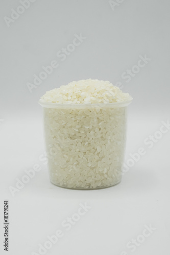 Japanese Rice Full In The A Cup On A White Background Rice Grains Are Pale Yellow And White Rice Is Full Of Carbohydrate And Nutrition Contained In A Transparent Measuring Cup Stock Japanese Rice Full In The A Cup On A White Background Rice Grains Are Pale Yellow And White Rice Is Full Of Carbohydrate And Nutrition Contained In A Transparent Measuring Cup Stock