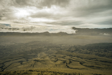 Golden outcast sky and sand dune in a national volcanic park. The cloudy sky and the desert landscape. 