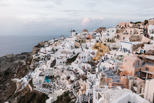 View Of Famous White Buildings Of Oia Town On Cliff In Santorini, Greece