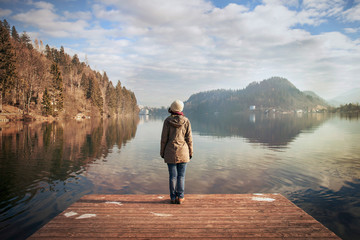 young woman looking over the lake, winter atmosphere in Bled’s lake