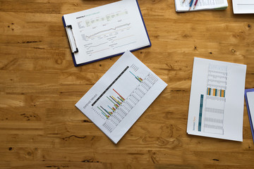 Wall Mural - Top view of business paper chart or graph on wooden table