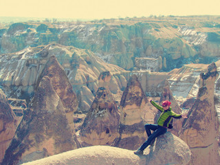 Wall Mural - young woman posing against a background of bizarre formations in cappadocia in turkey